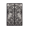 One black gates with intricate scrollwork designs. The gates are open and the scrollwork is visible through the openings. The text 'WITH THE HEART OF ONE' is visible through the scrollwork.