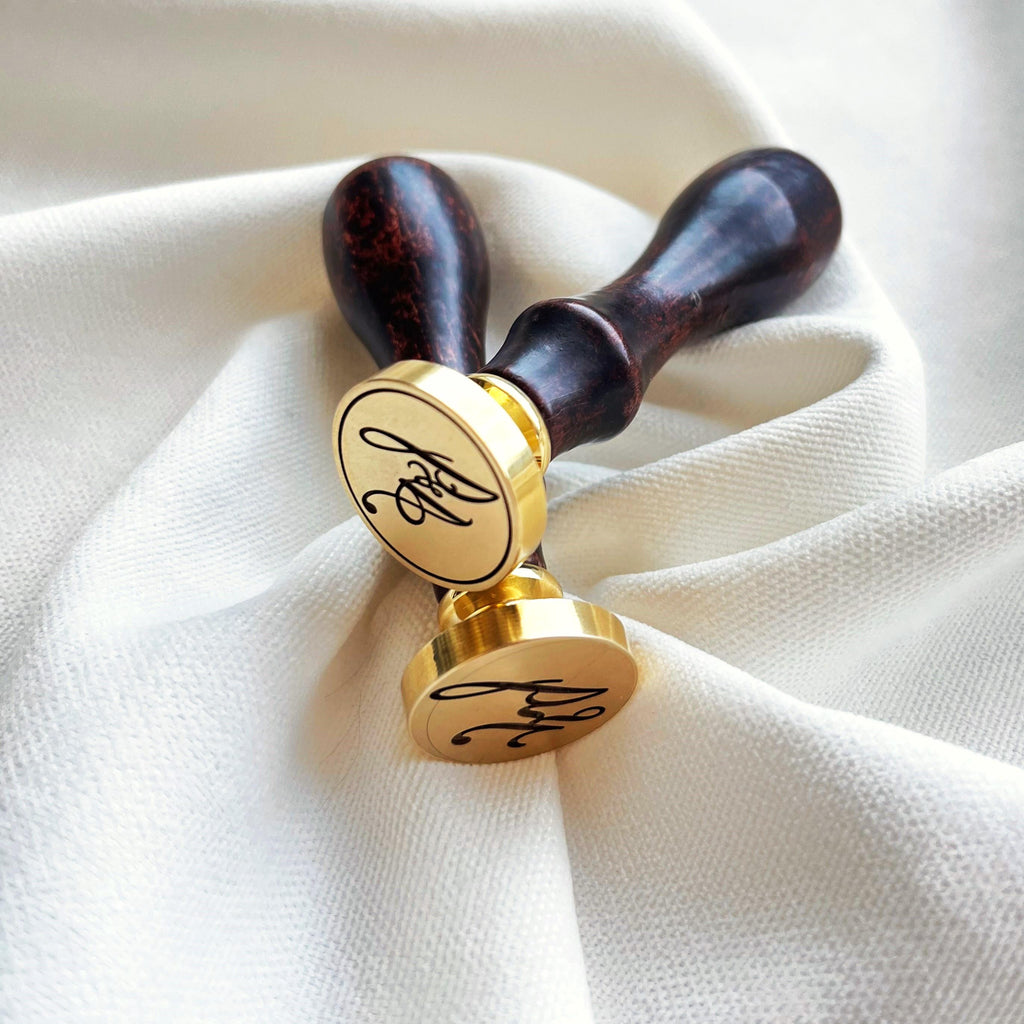 Two high-quality wax seal stamps with smooth wooden handles and precision-engraved custom initials.