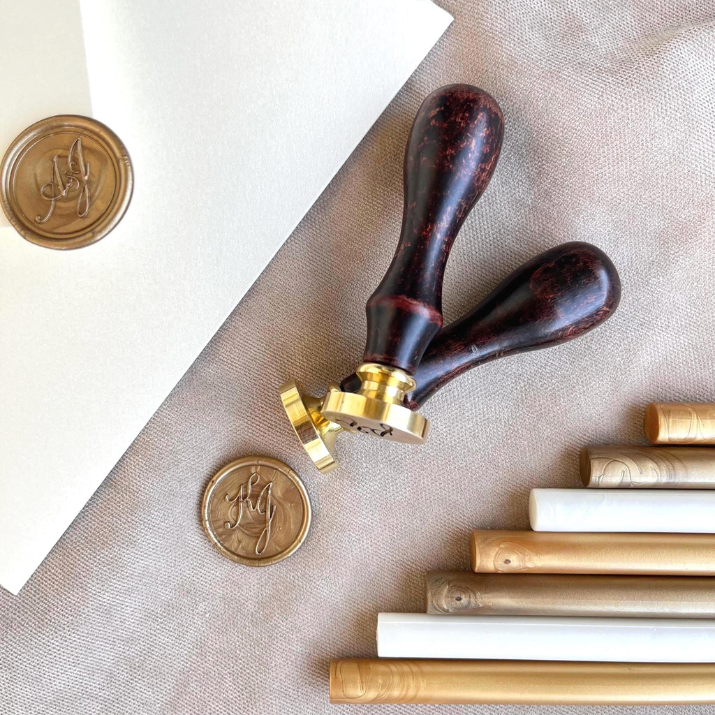 Two high-quality wax seal stamps with smooth wooden handles and precision-engraved custom initials. To complete the look, you'll also receive wax sticks in a refined color palette: old gold, aurum, and white — ideal for elegant, timeless sealing.