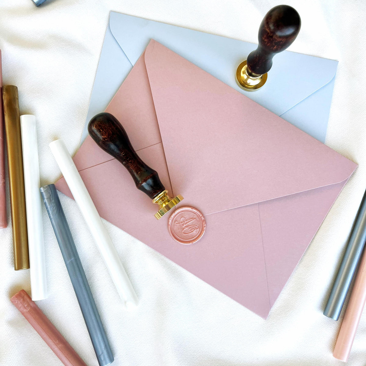 Two high-quality wax seal stamps with smooth wooden handles and precision-engraved custom initials.
